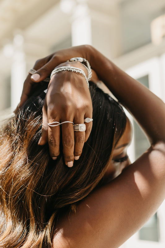 Woman showing off her diamond rings and bracelets